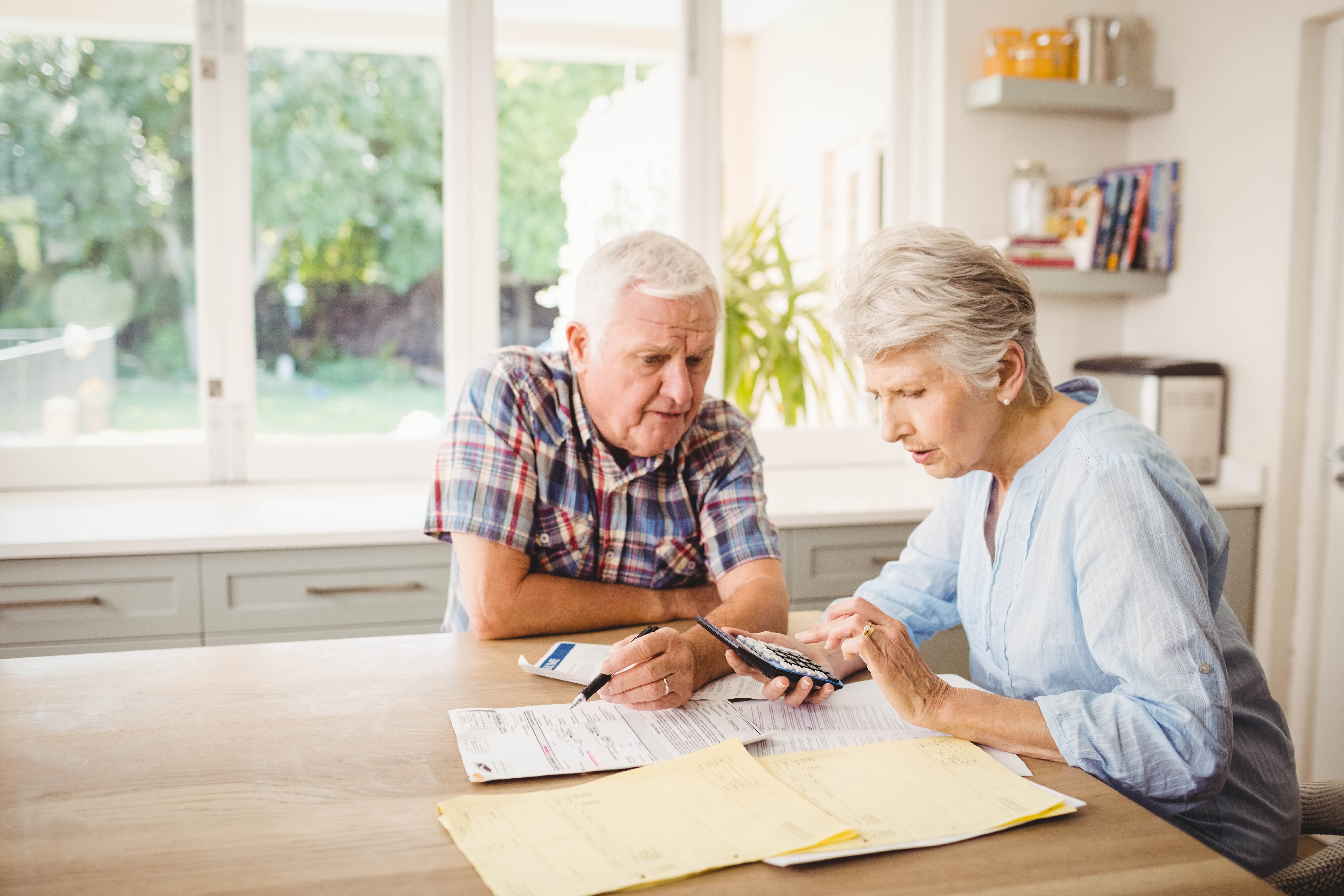 seniors with calculator and papers looking into downsizing