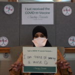 Barclay Friends Employee with vaccine sign