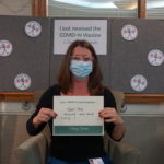 Barclay Friends Employee with vaccine sign