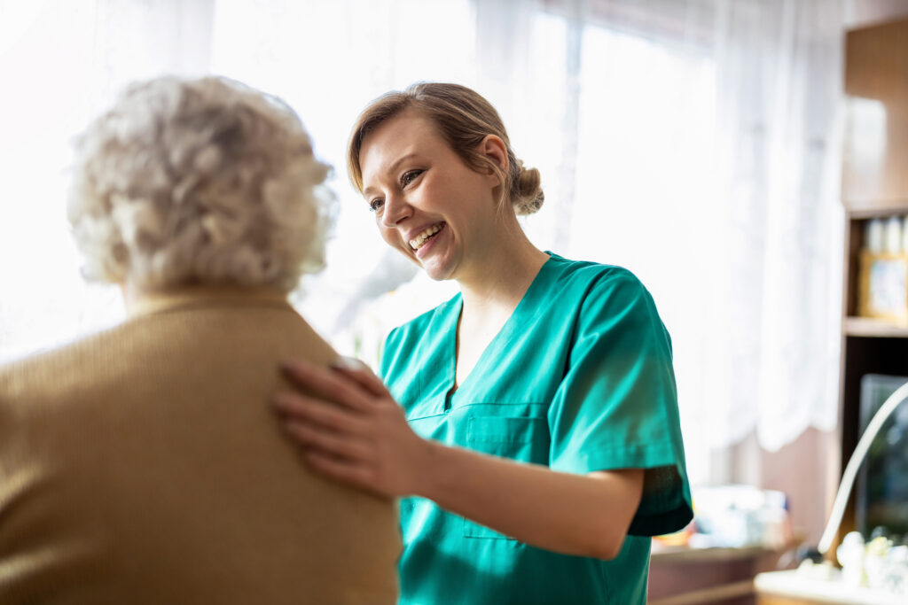female nurse cares for senior woman in her home.