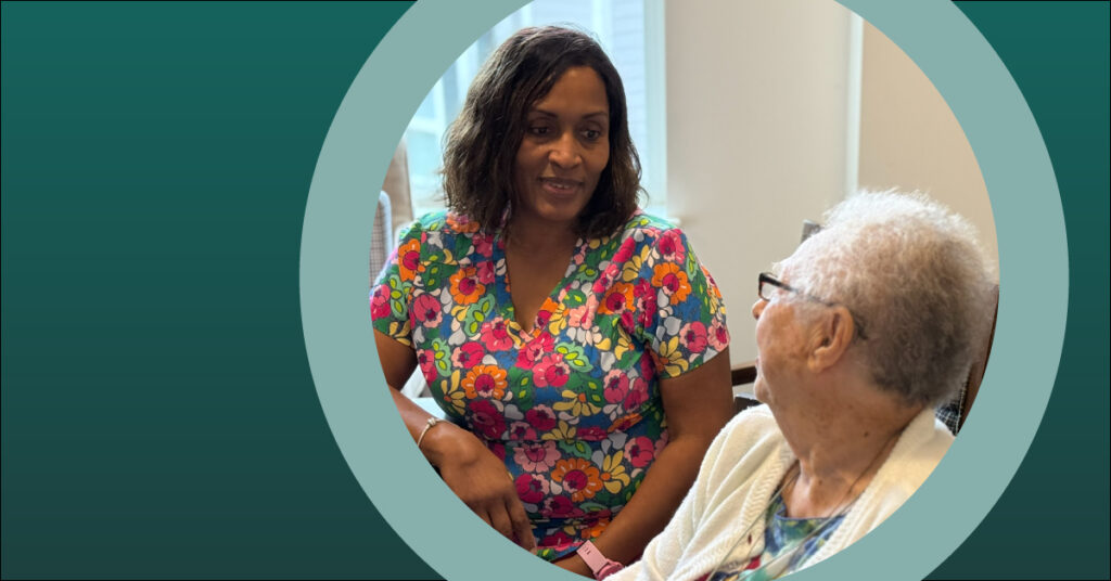 A nurse in colorful scrubs and an older woman in an assisted living community